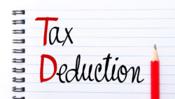 59336632 - td tax deduction written on notebook page with red pencil on the right